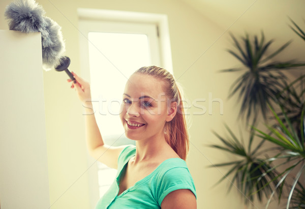 happy woman with duster cleaning at home Stock photo © dolgachov