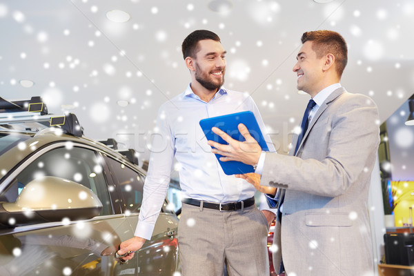 happy man with car dealer in auto show or salon Stock photo © dolgachov