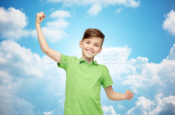 happy boy in polo t-shirt showing strong fists Stock photo © dolgachov