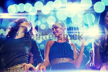 happy young women dancing at night club disco Stock photo © dolgachov