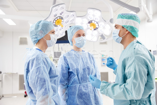 group of surgeons in operating room at hospital Stock photo © dolgachov