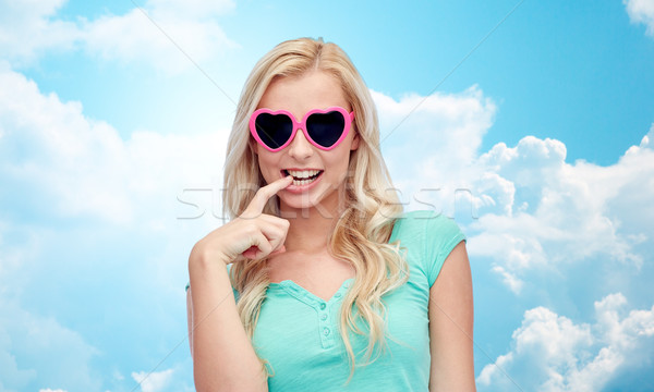 happy young woman in heart shape sunglasses Stock photo © dolgachov