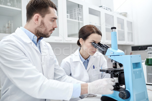 young scientists making test or research in lab Stock photo © dolgachov