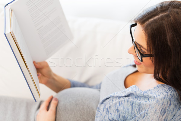 close up of pregnant woman reading book at home Stock photo © dolgachov