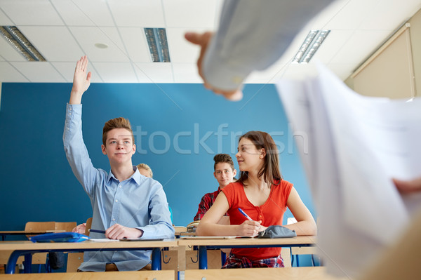 group of students and teacher with papers or tests Stock photo © dolgachov