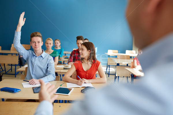 group of students and teacher with papers or tests Stock photo © dolgachov