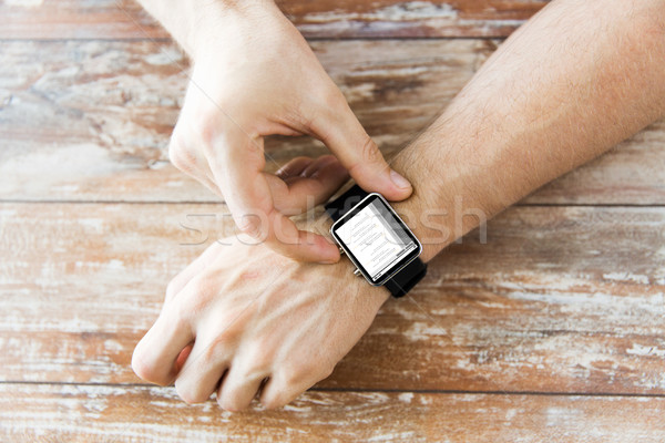 close up of hands with coding on smart watch Stock photo © dolgachov