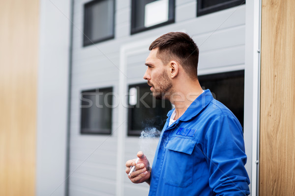 auto mechanic smoking cigarette at car workshop Stock photo © dolgachov