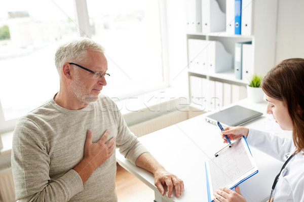 Stock photo: doctor showing cardiogram to old man at hospital