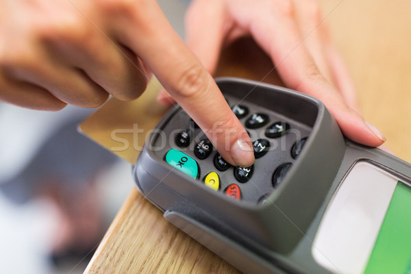 close up of hand entering code to money terminal Stock photo © dolgachov