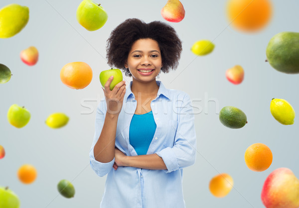 happy african american woman with green apple Stock photo © dolgachov