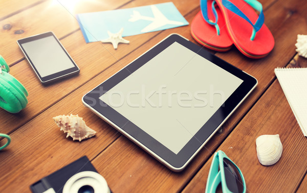 close up of tablet pc and travel stuff Stock photo © dolgachov