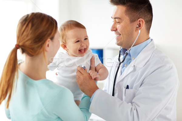 doctor with stethoscope and baby at clinic Stock photo © dolgachov