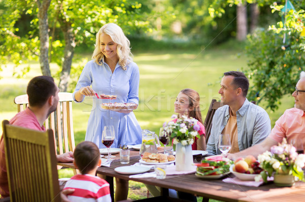 Stock photo: happy family having dinner or summer garden party