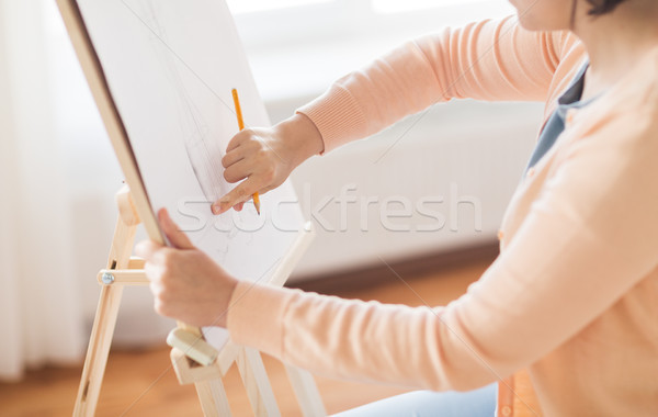 artist with pencil drawing picture at art studio Stock photo © dolgachov