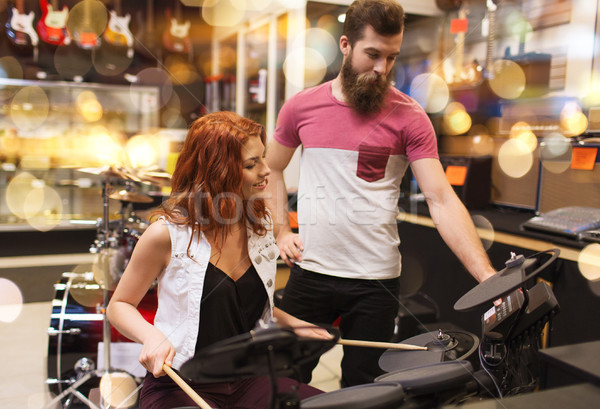 couple of musicians with drum kit at music store Stock photo © dolgachov