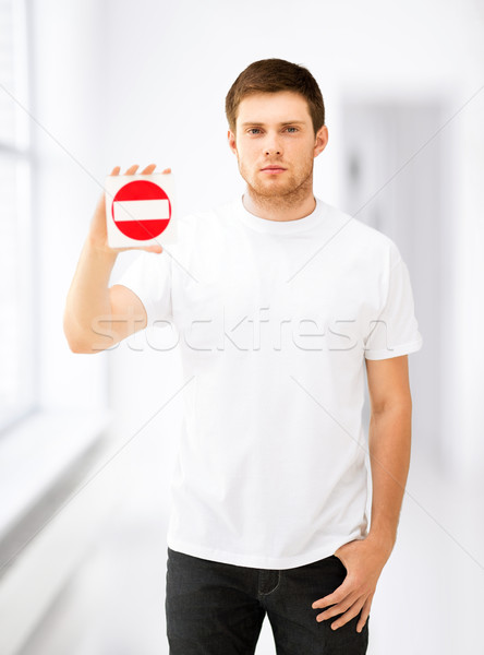 young man showing no entry sign Stock photo © dolgachov