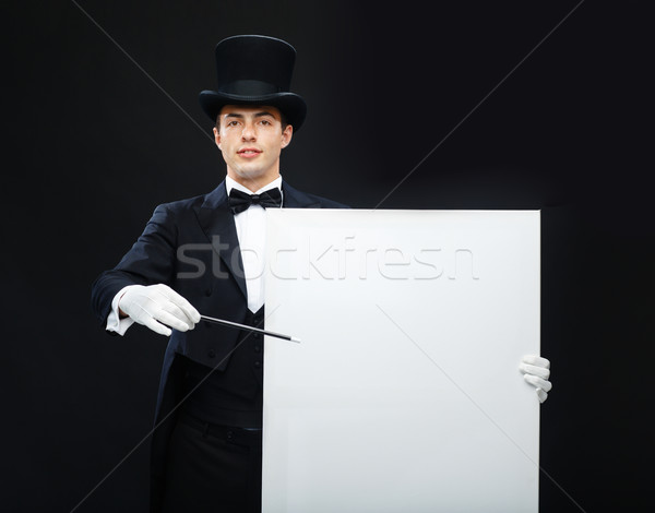 magician in top hat with magic wand showing trick Stock photo © dolgachov