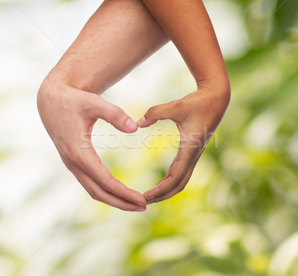 woman and man hands showing heart shape Stock photo © dolgachov