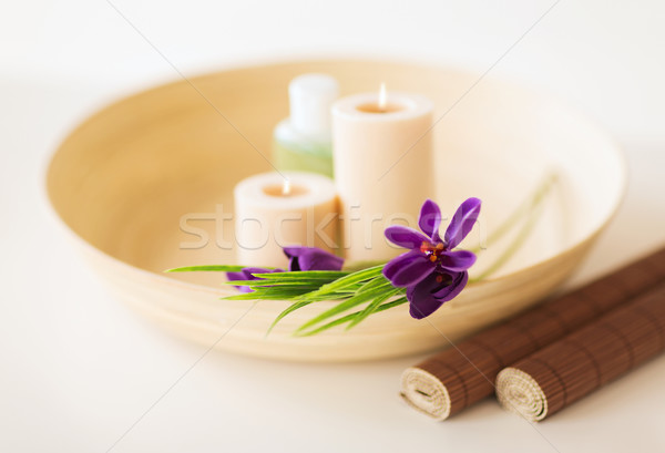 Stock photo: candles and iris flowers in wooden bowel and mat