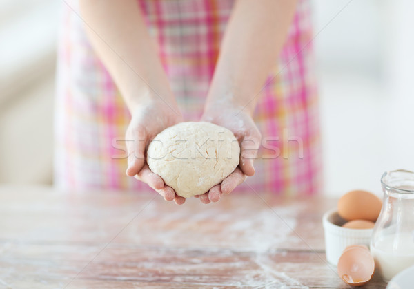 close up of female hands holding bread dough Stock photo © dolgachov