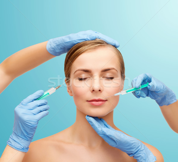 woman face and beautician hands with syringe Stock photo © dolgachov