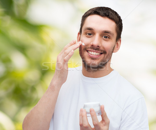 Schönen lächelnd Mann Sahne Gesundheit Schönheit Stock foto © dolgachov