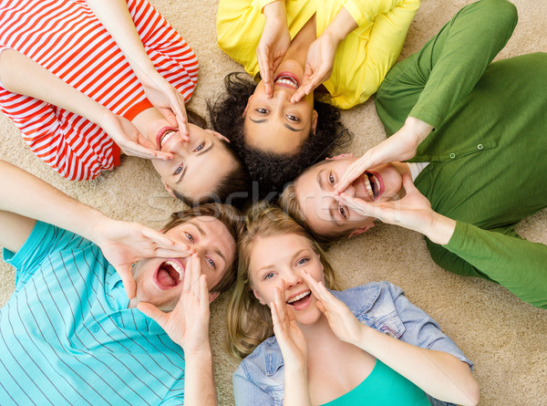 smiling people lying down on floor and screaming Stock photo © dolgachov