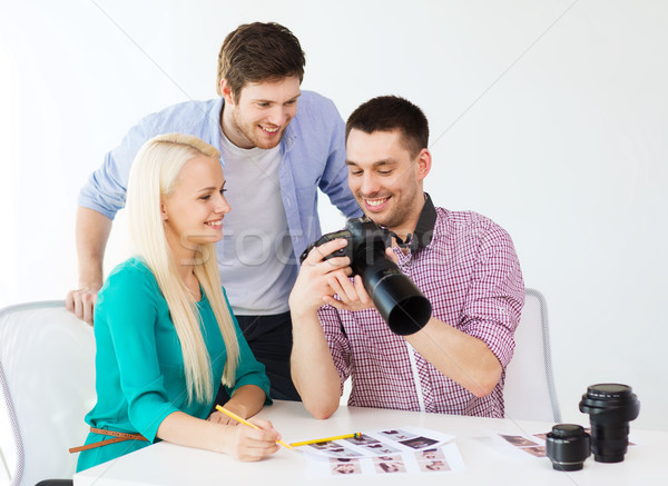 smiling team with photocamera working in office Stock photo © dolgachov