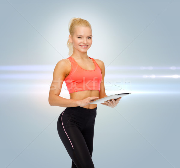 smiling sporty woman with tablet pc computer Stock photo © dolgachov