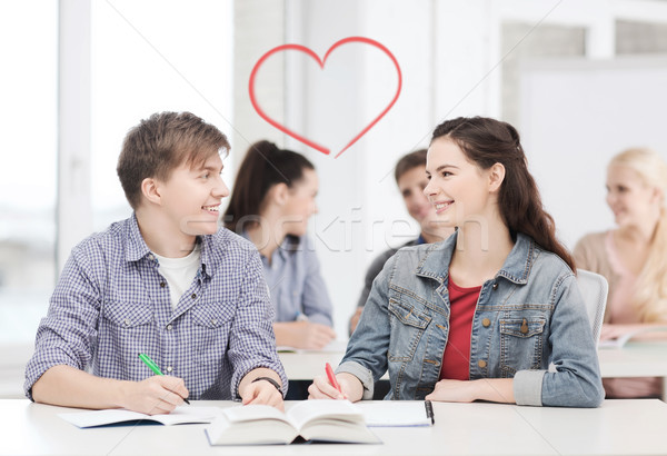 two teenagers with notebooks and book at school Stock photo © dolgachov