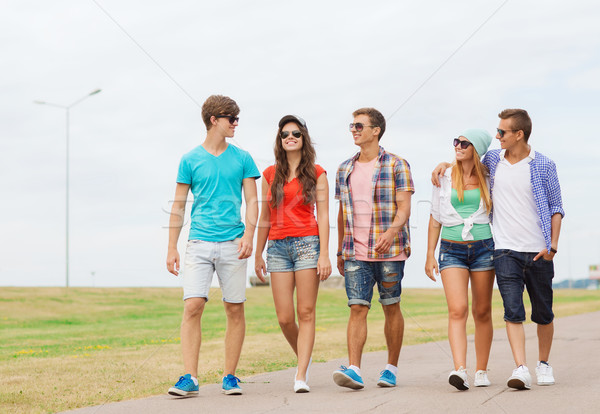 Stock photo: group of smiling teenagers walking outdoors