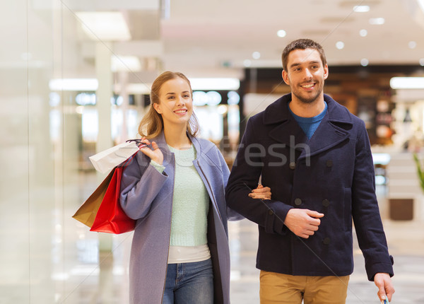 happy young couple with shopping bags in mall Stock photo © dolgachov