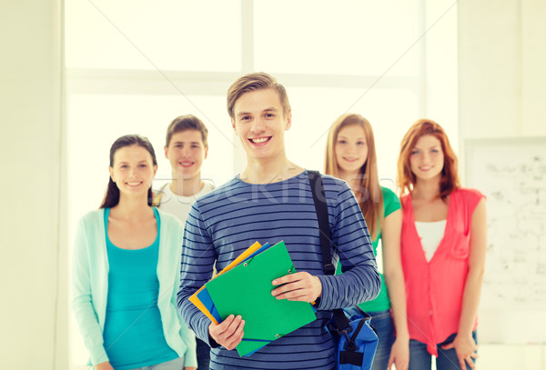 smiling students with teenage boy in front Stock photo © dolgachov
