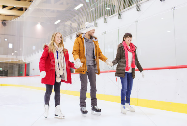 happy friends on skating rink Stock photo © dolgachov