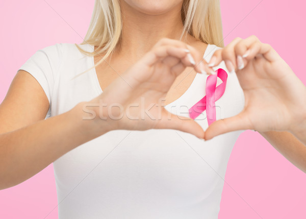 close up of woman and pink cancer awareness ribbon Stock photo © dolgachov