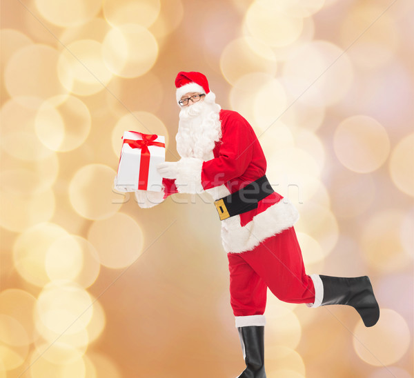 man in costume of santa claus with gift box Stock photo © dolgachov