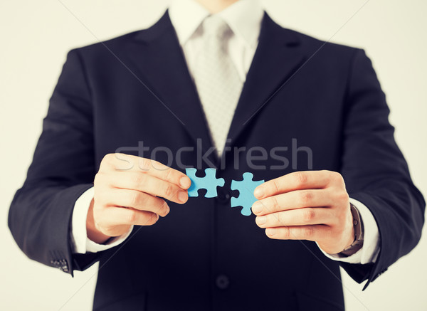 man trying to connect puzzle pieces Stock photo © dolgachov