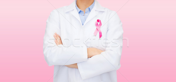 smiling female doctor with cancer awareness ribbon Stock photo © dolgachov