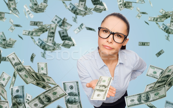 businesswoman with money over blue background Stock photo © dolgachov