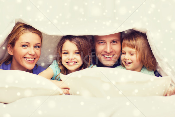 happy family with two kids under blanket at home Stock photo © dolgachov
