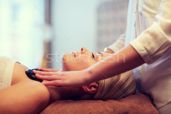 close up of woman having hot stone massage in spa Stock photo © dolgachov