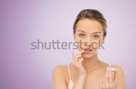Jeune femme lèvre baume lèvres beauté Photo stock © dolgachov