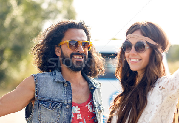 Stock photo: smiling young hippie couple over minivan car