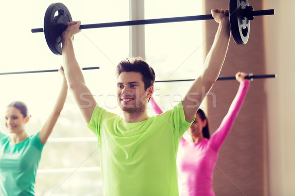 Stock photo: group of people exercising with barbell in gym