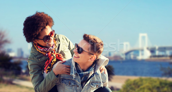 happy teenage couple in shades having fun outdoors Stock photo © dolgachov