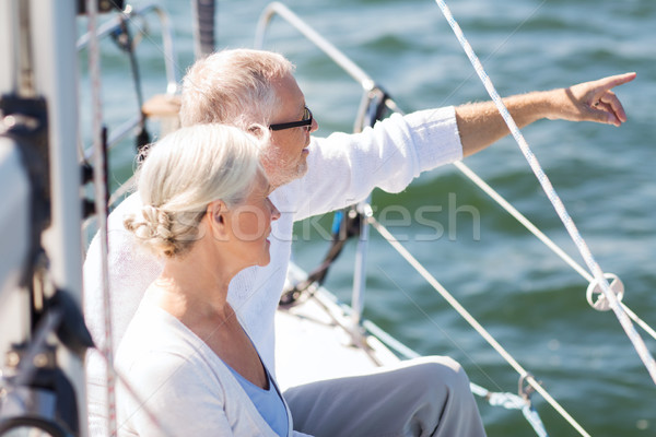 Stock photo: happy senior couple on sail boat or yacht in sea