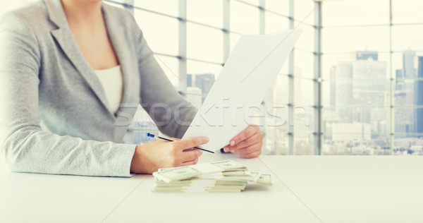 close up of female hands with money and tax report Stock photo © dolgachov