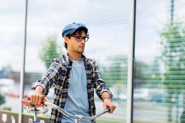 hipster man walking with fixed gear bike Stock photo © dolgachov