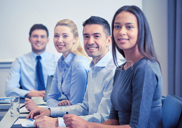 group of smiling businesspeople meeting in office Stock photo © dolgachov